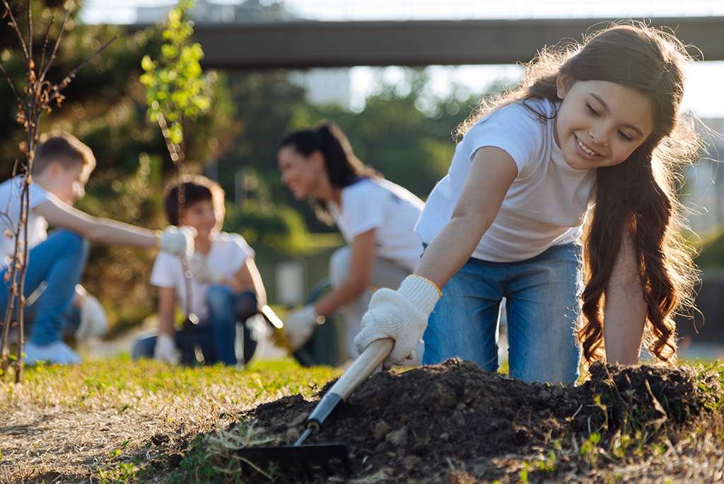 A little girl planting in the garden