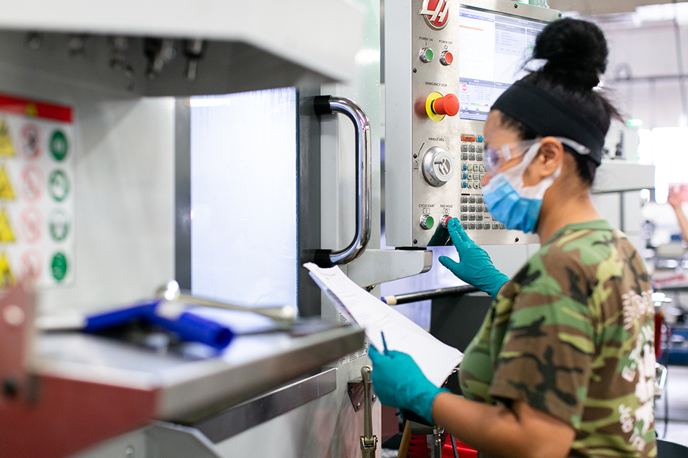 A photo of a woman working in an industrial facility 