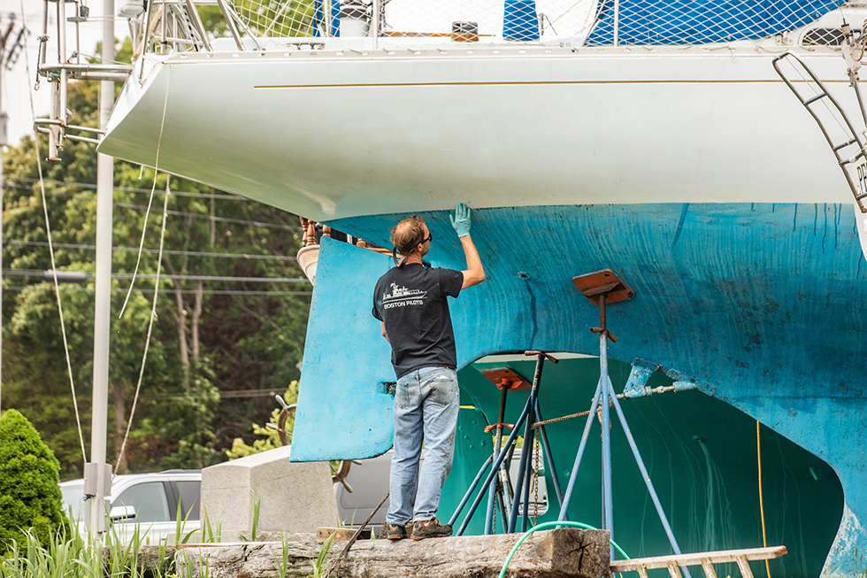 Man painting a large boat