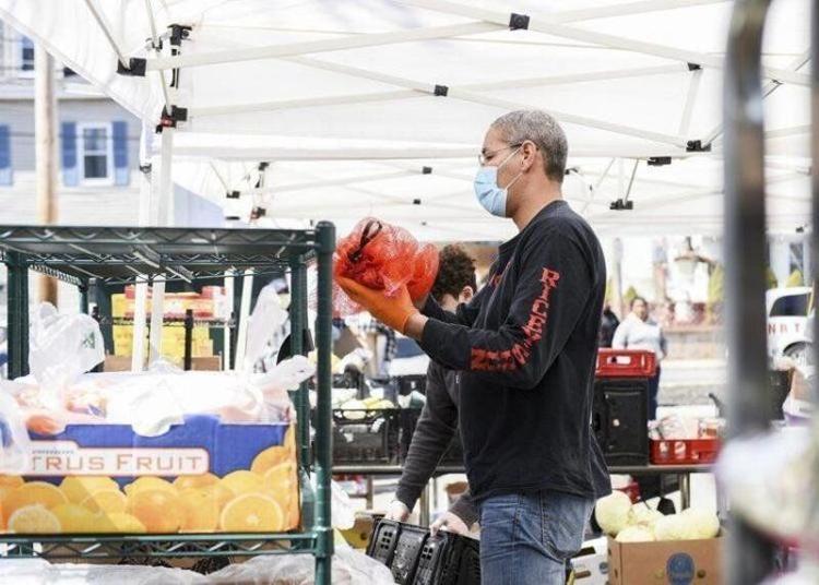 Peabody firefighter Russell Lewis organizes food items at the Haven From Hunger Citizens Inn in Peabody last April.